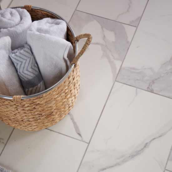 tile in bathroom with basket of towels